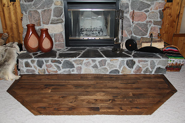 Tulsi Hickory Organic solid hardwood flooring in front of a fireplace.